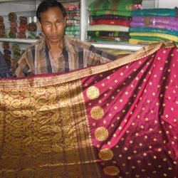 Salesman displaying a traditional Assamese saree at govt-run handloom stall 'Jagaran''. Photo: Subhrajyoti Baruah.