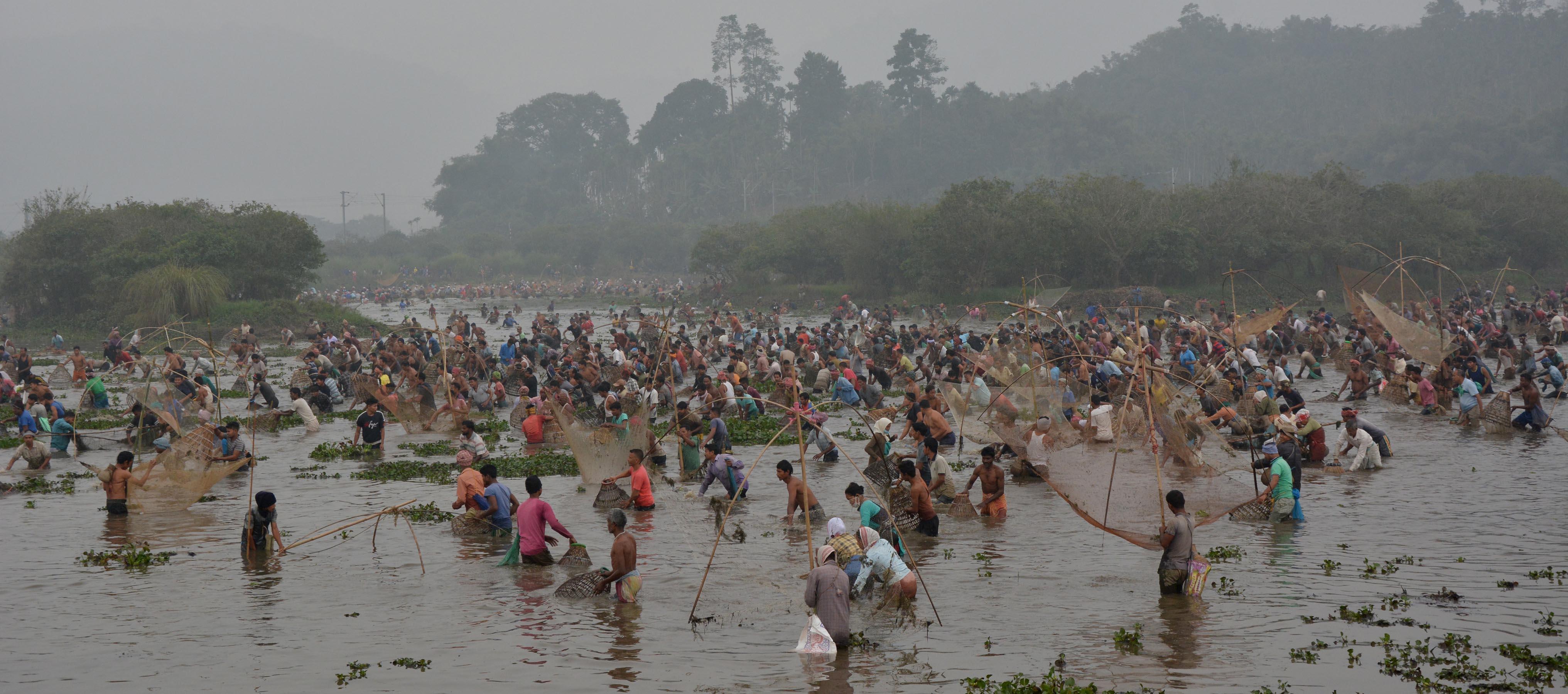 Villagers participate in community fishing during the Bhogali Bihu celebration at Goroimari Lake in Panbari village, some 50 kilometers (31 miles) in Guwahati, India, Jan. 13, 2021. “Bhogali Bihu” is a harvest festival celebrated in Assam which marks the end of the harvesting season. The celebrations include community feast and prayers to the Fire God not to unleash its wrath during the summers. Pix by ub photos