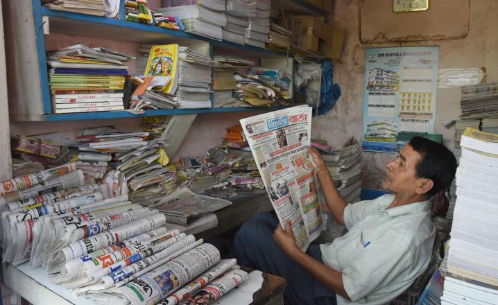 A newspaper salesman reads a local newspaper during Janata Curfew at Tezpur on 22-03-2020. Pix by UB Photos