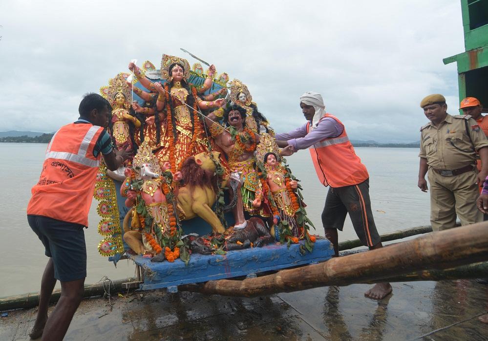 GMC worker carrying an idol of Goddess Durga for immersion in the Brahmaputra river on Bijoya Dashami at Kasomari Ghat in Guwahati on Saturday. Photo  by UB Photos