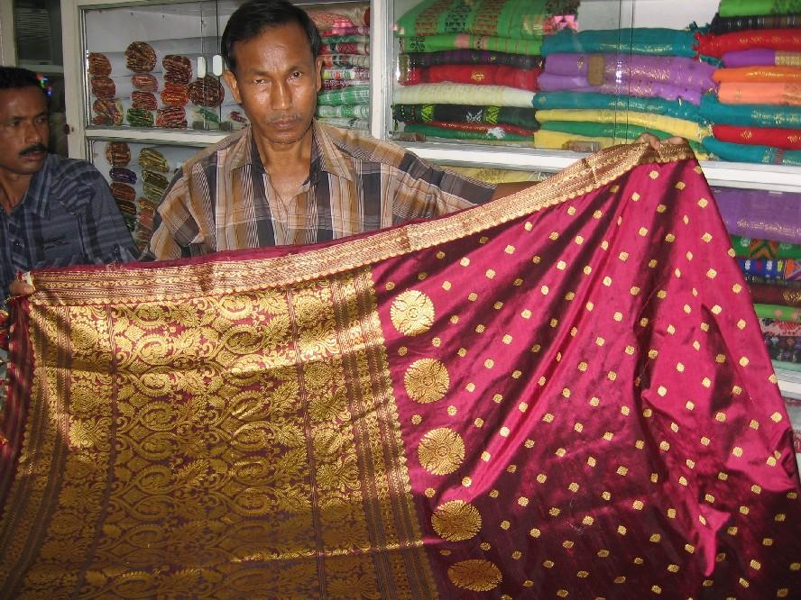 Salesman displaying a traditional Assamese saree at govt-run handloom stall 'Jagaran''. Photo: Subhrajyoti Baruah.