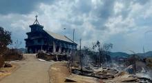 File Photo: burnt church and houses in Langching village on May 31, 2023