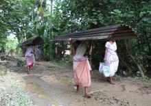 Fresh effort: Women heading home to build their ravaged homes afresh in Guri Jan Gohain Village, Gogamukh in Dhemaji District on Thursday. Photo by UB Photos