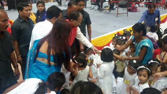 Smiling Gogoi talks to children 