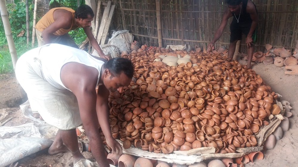 MA degree holder making earthen lamps
