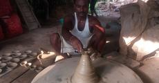 MA degree holder making earthen lamps