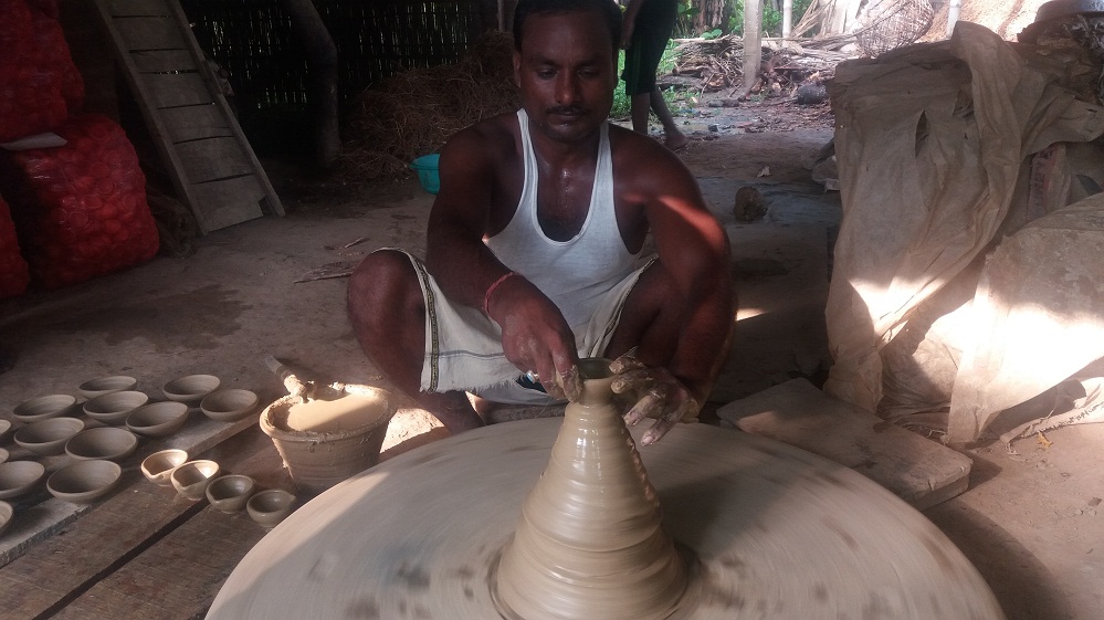 MA degree holder making earthen lamps