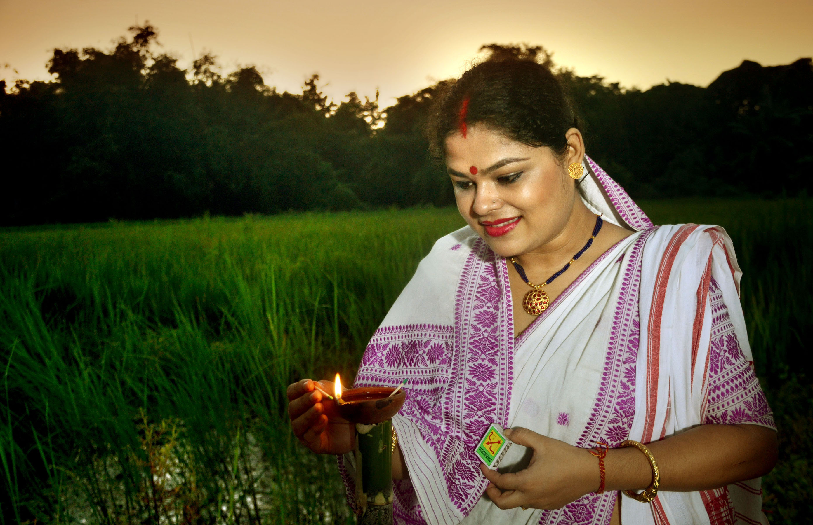 Earthen lamps lit up marking Kati Bihu